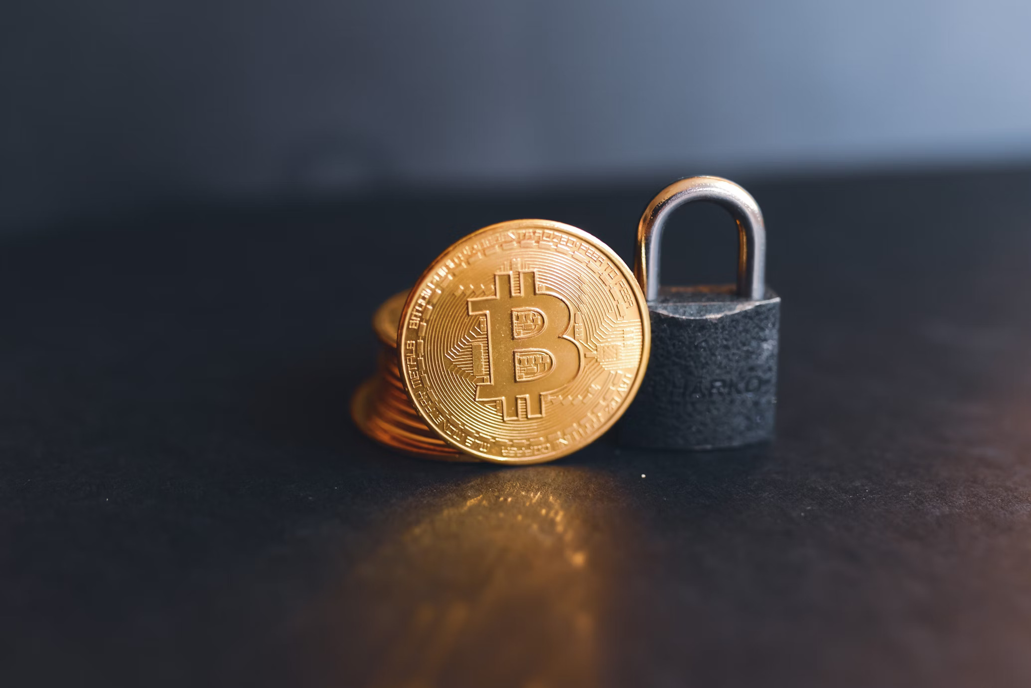 A bitcoin on top of a padlock
